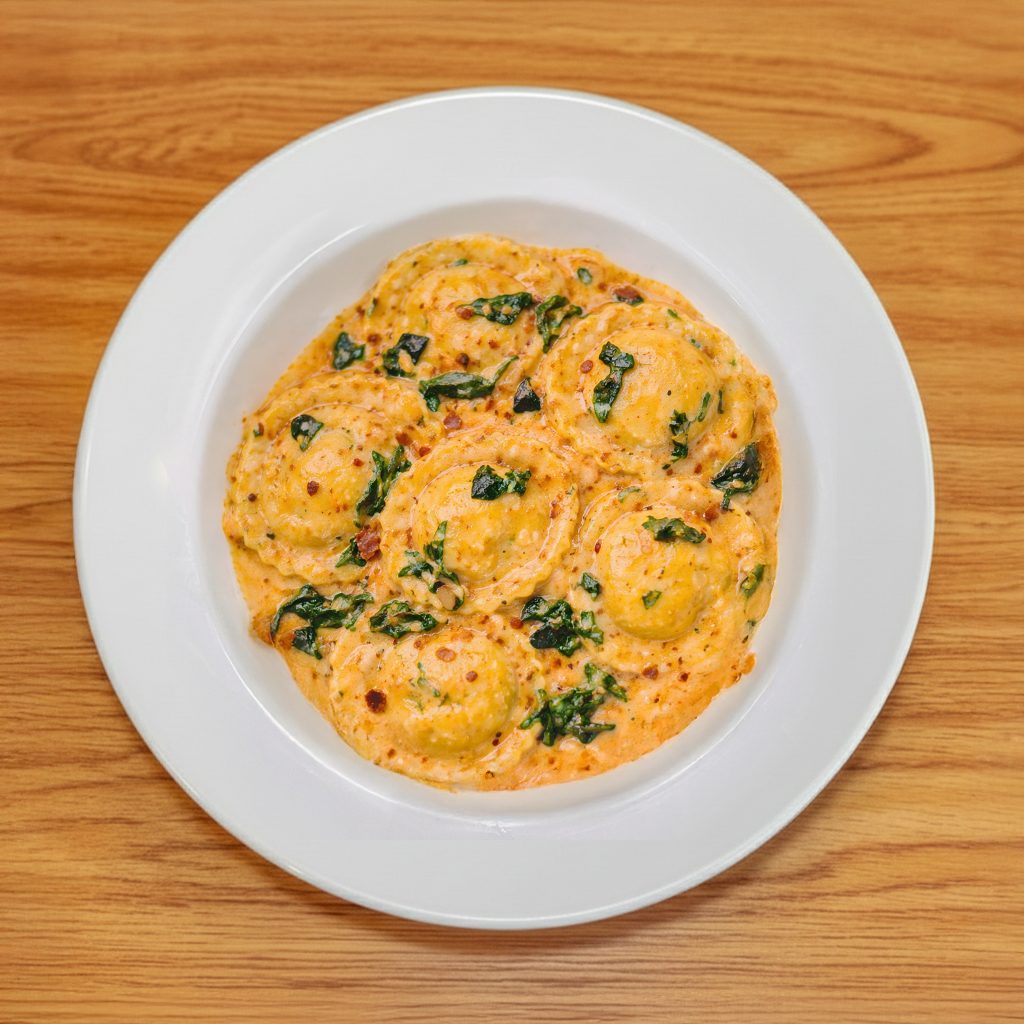 Spinach & Cheese Ravioli in Roasted Red Bell Pepper Sauce.