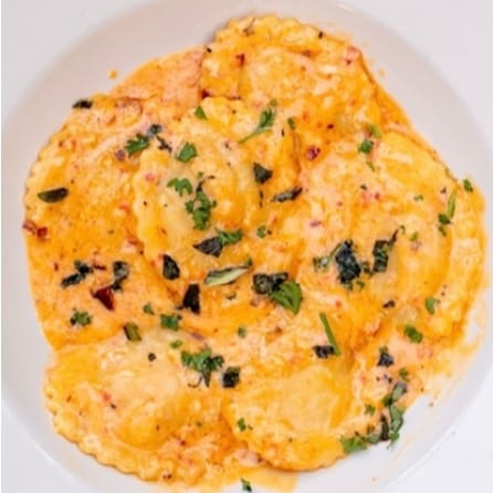 Spinach & Cheese Ravioli in Roasted Red Bell Pepper Sauce.